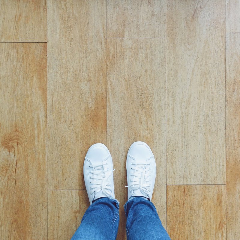 POV feet on Wood AdobeStock_247266604